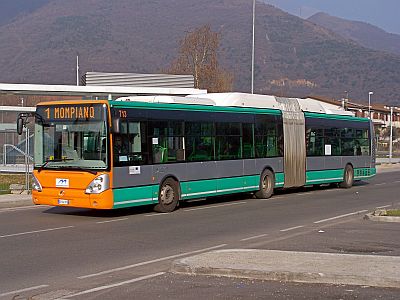 Brescia metro bus with orange front, white roof and green and grey striped sides