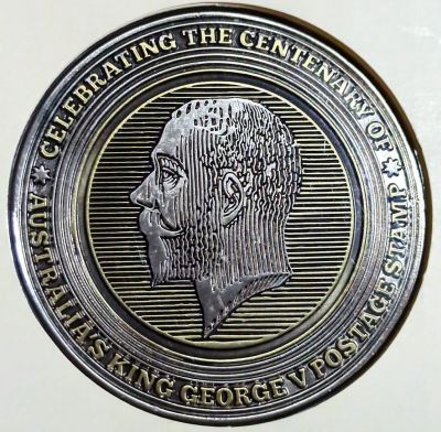 Obverse of the medallion with same text around edge and the closeup of the King's portrait in the center