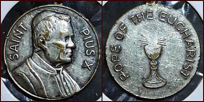 Small white metal medallion: Obverse: SAINT PIUS X / (Image of Pius X facing right) Reverse: POPE OF THE EUCHARIST / (Eucharist)