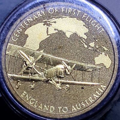 Reverse of the coin The coin portrays a representation of the Vickers aircraft that made the harrowing expedition and a map of the flight path. Script: Latin Lettering: CENTENARY OF THE FIRST FLIGHT P JM ENGLAND TO AUSTRALIA Designer: Jennifer McKenna