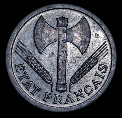 Double-headed axe in centre with ear of wheat either side, lettering below. Lettering on top and bottom of axe NOTE: If there is a mintmark it is on the left, above the wheat and to the side of the head NOTE: The 1943 Essai coin has ESSAI above the axe Script: Latin Lettering: ÉTAT FRANÇAIS S PACIS PETAIN Engraver: Lucien Georges Bazor Read more on Wikipedia