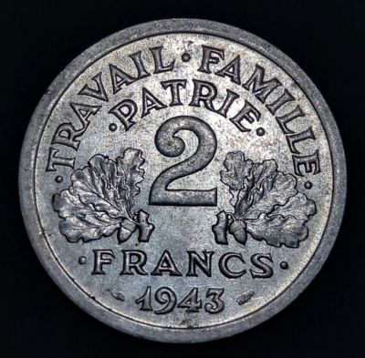 Oak leaves either side of central numeral, lettering above, lettering below with date Script: Latin Lettering: ·TRAVAIL·FAMILLE· ·PATRIE· 2 ·FRANCS· 1943 Translation: ·WORK·FAMILY· ·MOTHERLAND· 2 ·FRANCS· 1943 Engraver: Lucien Georges Bazor Read more on Wikipedia