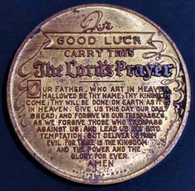FOR / GOOD LUCK / CARRY THIS / THE LORD'S PRAYER / OUR FATHER, WHO ART IN HEAVEN, / HALLOWED BE THY NAME. THY KINGDOM / COME, THY WILL BE DONE ON EARTH AS IT IS / IN HEAVEN. GIVE US THIS DAY OUR DAILY / BREAD, AND FORGIVE US OUR TRESPASSES, / AS WE FORGIVE THOSE WHO TRESPASS / AGAINST US. AND LEAD US NOT INTO / TEMPATION, BUT DELIVER US FROM / EVIL. FOR THINE IS THE KINGDOM / AND THE POWER AND THE / GLORY FOR EVER. / AMEN / WHITEHEAD ROAD