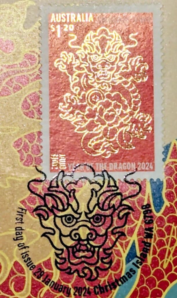 Stamp with "Australia $1.20" at the top, a dragon and the Chinese symbol for Dragon below, all in gold leaf, with YEAR OF THE DRAGON 2024 in white, all on a red background. The postmark is a black dragon's head with "First day of issue 29 January 2024 Christmas Island WA 6798