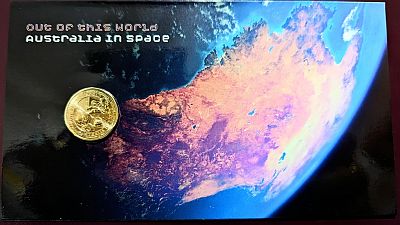 Insert Card showing the reverse of the coin, the text "Out of this world" and "Australia in Space" top-left with a satellite view of Australia