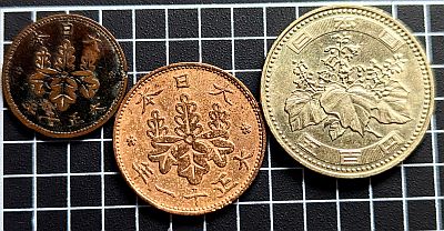 Reverse of 5 Rin, 1 Sen and 500 Yen coins showing Paulowina flowers