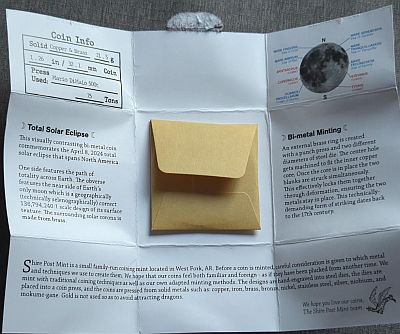 Packaging open with a yellow coin envelope in the centre and statistics around the outside.