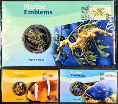 Front of the three PNCs showing stamps top-right, medallion mid-left "Marine Emblems" title above and image of the emblem on the right.  Top is South Australia's Leafy Sea Dragon in green and blue.  Lower-Left Queensland's Barrier Reef Anemonefish in orang and yellow, and lower-right NSW's Eastern Blue Groper in blue