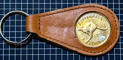 Leather keyring with gilded penny set inside plastic holder. Reverse (Kangaroo side) facing (the obverse is visible from the other side of the keyring)