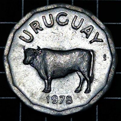 A darker, more directly lit image of the obverse: Standing steer, facing left, date on exergue; short name of the country on top. The steer is one of the symbols of national coat of arms, where shows on lower right quarter, and symbolizes the abundance. Script: Latin Lettering: URUGUAY So 1977