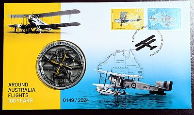 Left third of envelope is gold, right two thirds is white gradiating to blue. Land plane pictured top-left with sea plane lower right, stamps upper-right and medallion centre-left (centred on the border of the gold